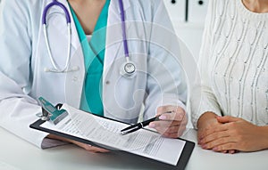 Doctor and patient, close-up of hands. Physician talking about medical examination results. Medicine, healthcare an