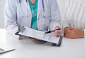 Doctor and patient, close-up of hands. Physician talking about medical examination results. Medicine, healthcare an