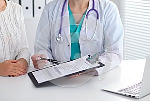 Doctor and patient, close-up of hands. Physician talking about medical examination results. Medicine, healthcare an