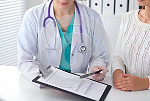 Doctor and patient, close-up of hands. Physician talking about medical examination results. Medicine, healthcare an