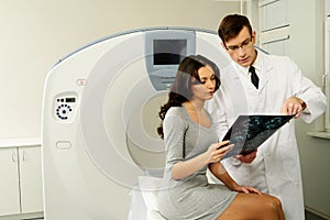 Doctor with patient at the computed tomography photo