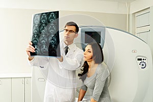 Doctor with patient at computed tomography photo