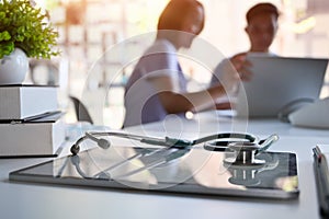 Doctor and patient consult in blur background and medical equipment on hospital workspace