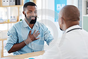 Doctor, patient and consulting in healthcare checkup, illness or appointment at the hospital. Black man talking to