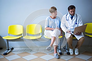 Doctor and patient discussing over laptop