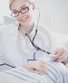 Doctor and patient discussing something while sitting at the table . Medicine and health care concept