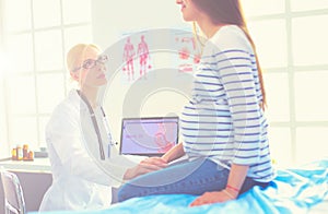 Doctor and patient discussing something while sitting at the table . Medicine and health care concept