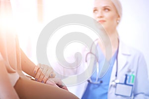 Doctor and patient discussing something while sitting at the table . Medicine and health care concept. Doctor and