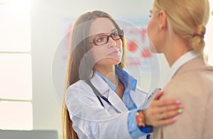 Doctor and patient discussing something while sitting at the table . Medicine and health care concept. Doctor and