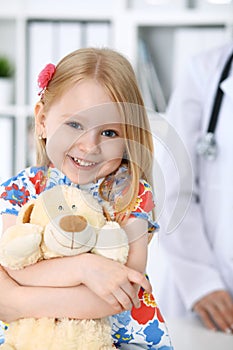 Doctor and patient in hospital. Child being examined by physician with stethoscope