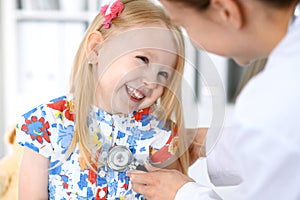 Doctor and patient in hospital. Child being examined by physician with stethoscope