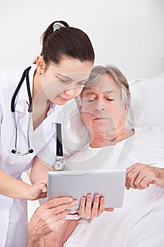 Doctor and patient looking at digital tablet