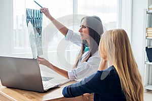 Doctor and patient looking at x-ray or MRI concept