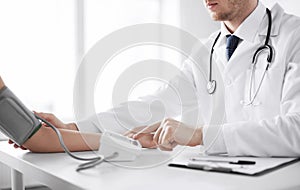 Doctor and patient measuring blood pressure