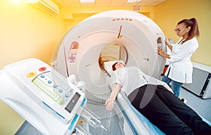 Doctor and patient in the room of computed tomography at hospital.