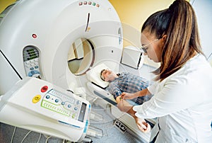 Doctor and patient in the room of computed tomography at hospital.