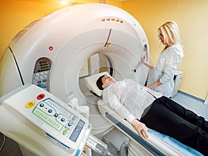 Doctor and patient in the room of computed tomography at hospital.