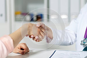 Doctor and patient shaking hands