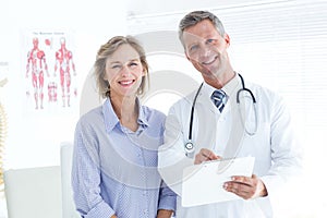 Doctor and patient smiling at camera