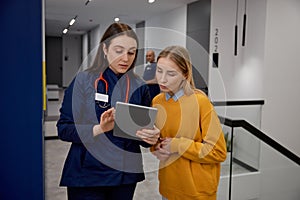 Doctor and patient talking discussing something looking at digital tablet