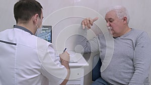 Doctor during patient visit talking about upcoming treatment, test results