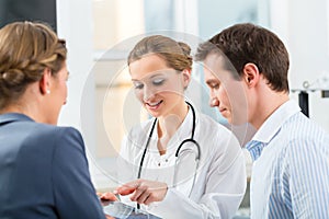 Doctor with patients in a consulting in clinic
