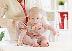 Doctor pediatric examining little baby in clinic. Baby health concept