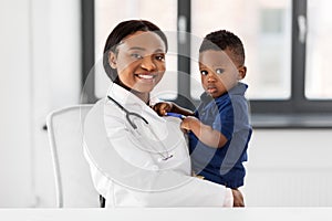 Doctor or pediatrician with baby patient at clinic