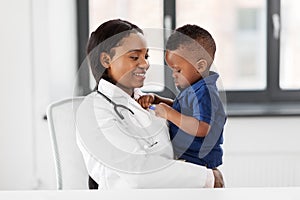 Doctor or pediatrician with baby patient at clinic