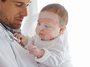 Doctor, pediatrician and baby playing with stethoscope for healthcare assessment, medical support and growth. Newborn