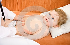 Doctor pediatrician exam baby abdomen photo