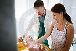 Doctor pediatrician with mother and baby child in clinic. Hospital, examining, child concept.