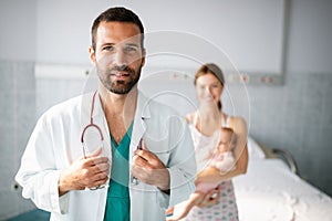 Doctor pediatrician with mother and baby child in clinic. Hospital, examining, child concept.