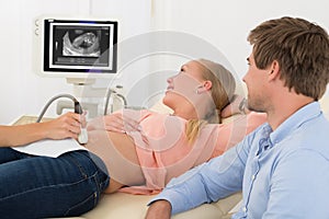 Doctor Performing Ultrasound Scan On Expecting Woman photo