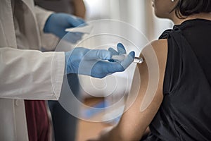 Doctor performs vaccination photo