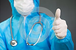 Doctor in Personal Protective Equipment with gesture up confidence and thumbs up