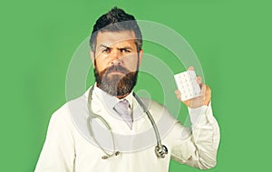 Doctor or pharmacist with pills. Physician in uniform with stethoscope. Medicine and healthcare.