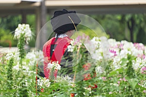 Doctor of Philosophy Graduate Elder Female Taking a Photo in the Beautiful Flower Garden.