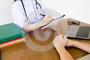 Doctor physician consulting with male patients in hospital exam room. Men`s health concept