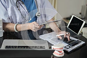 Doctor physician with stethoscope calculate medical fee costs & revenue.