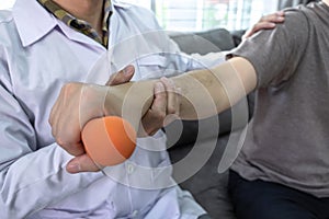 Doctor physiotherapist treating rehabilitation arm pain patient doing physical therapy exercises with his therapist treatment on