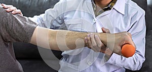 Doctor physiotherapist treating rehabilitation arm pain patient doing physical therapy exercises with his therapist treatment on
