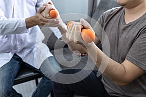 Doctor physiotherapist treating rehabilitation arm pain patient doing physical therapy exercises with his therapist treatment on