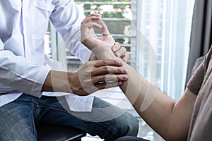 Doctor physiotherapist treating rehabilitation arm pain patient doing physical therapy exercises with his therapist treatment on