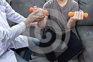 Doctor physiotherapist treating rehabilitation arm pain patient doing physical therapy exercises with his therapist treatment on