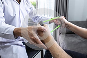 Doctor physiotherapist treating rehabilitation arm pain patient doing physical therapy exercises with his therapist treatment on