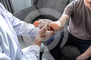 Doctor physiotherapist treating rehabilitation arm pain patient doing physical therapy exercises with his therapist treatment on