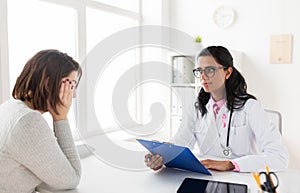 Doctor with pink awareness ribbon and sad patient