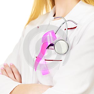 Doctor with pink cancer ribbon aids symbol on chest