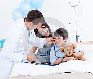 Doctor playing with a little boy and his mother